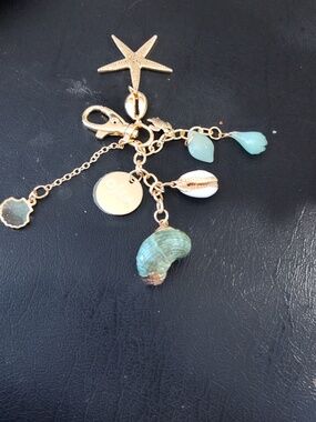 Sea Gold-Tone Coastal Charm Bracelet with Seafoam and Shell Accents